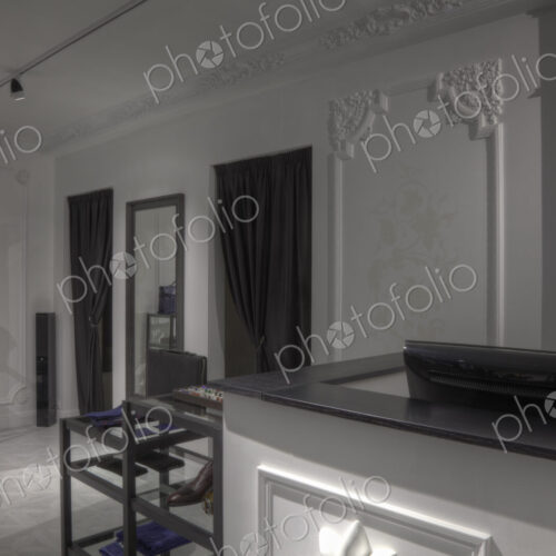Dressing rooms and cash register behind empty store counter Dressing rooms and cash register behind empty store counter