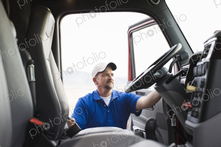 Driver getting into the cab of a commercial truck.