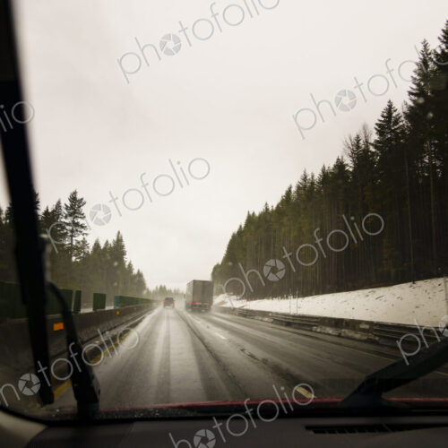 Driver's perspective through windshield of winter highway with semi-truck. Driver's perspective through windshield of winter highway with semi-truck.