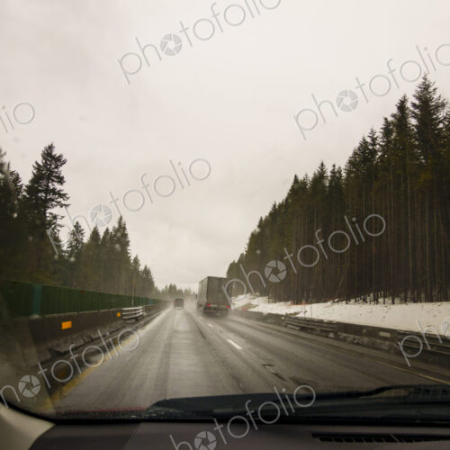 Driver's perspective through windshield of winter highway with semi-truck. Driver's perspective through windshield of winter highway with semi-truck.