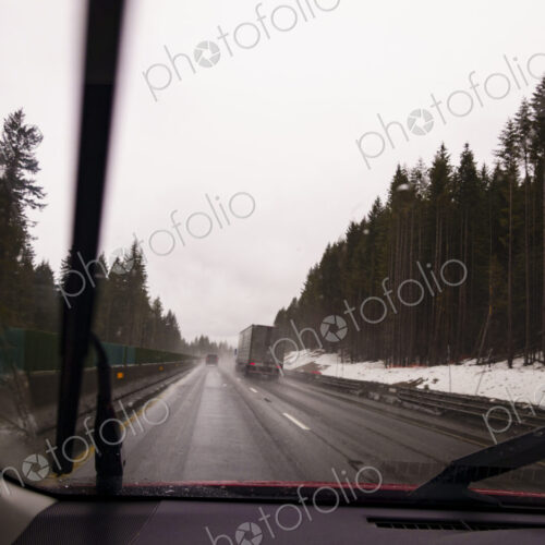 Driver's perspective through windshield of winter highway with semi-truck. Driver's perspective through windshield of winter highway with semi-truck.