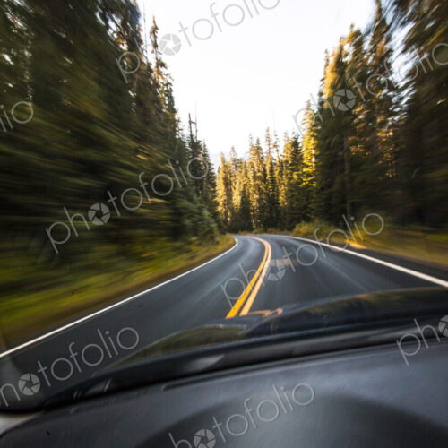 Driver's pov through windshield speeding down two lane highway, Mount Rainier National…