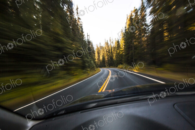 Driver's pov through windshield speeding down two lane highway, Mount Rainier National…