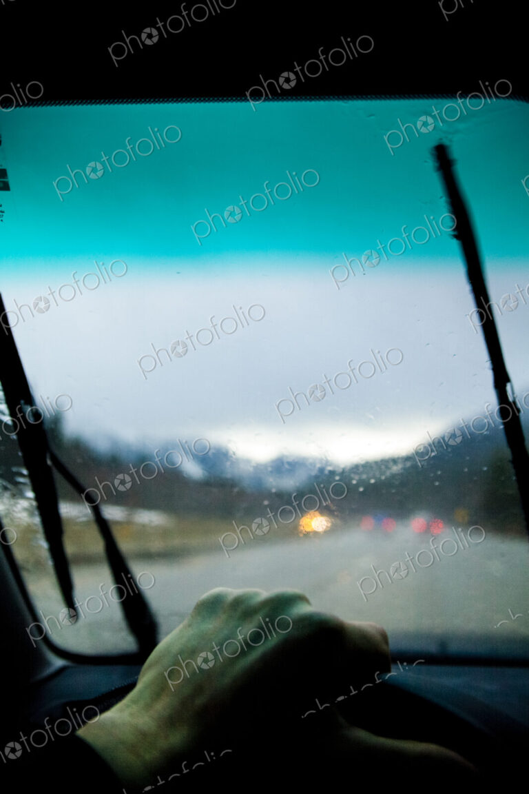 Driver's view through a car windshield on Interstate 90 during heavy rain.