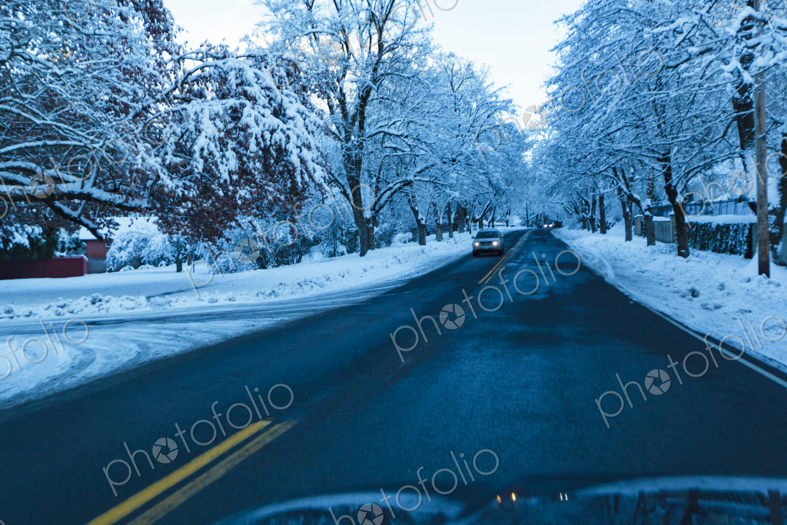Driver’s windshield view of driving on a residential road in winter, Spokane, WA USA