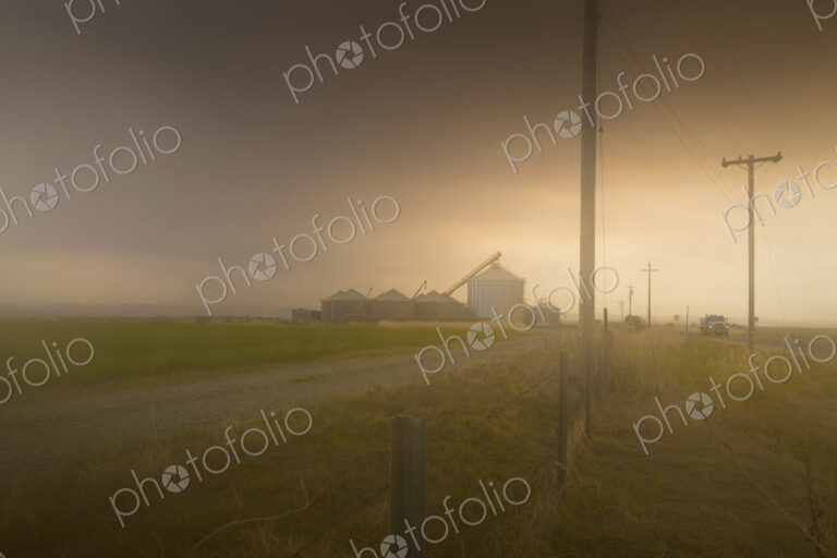 Dust storm over rural landscape