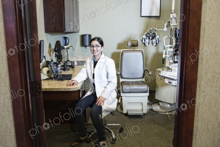 East Indian woman ophthalmologist in her office examination room.