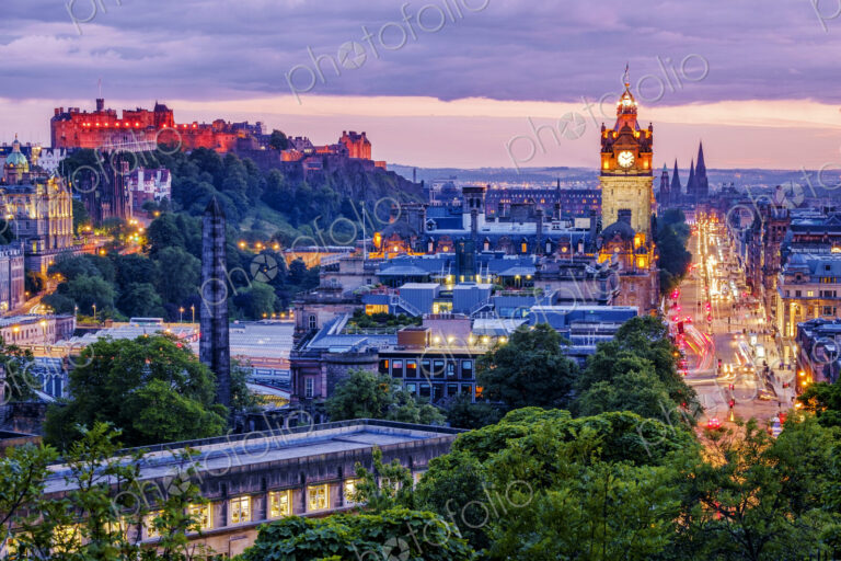 Edinburgh skyline lit up at dawn.