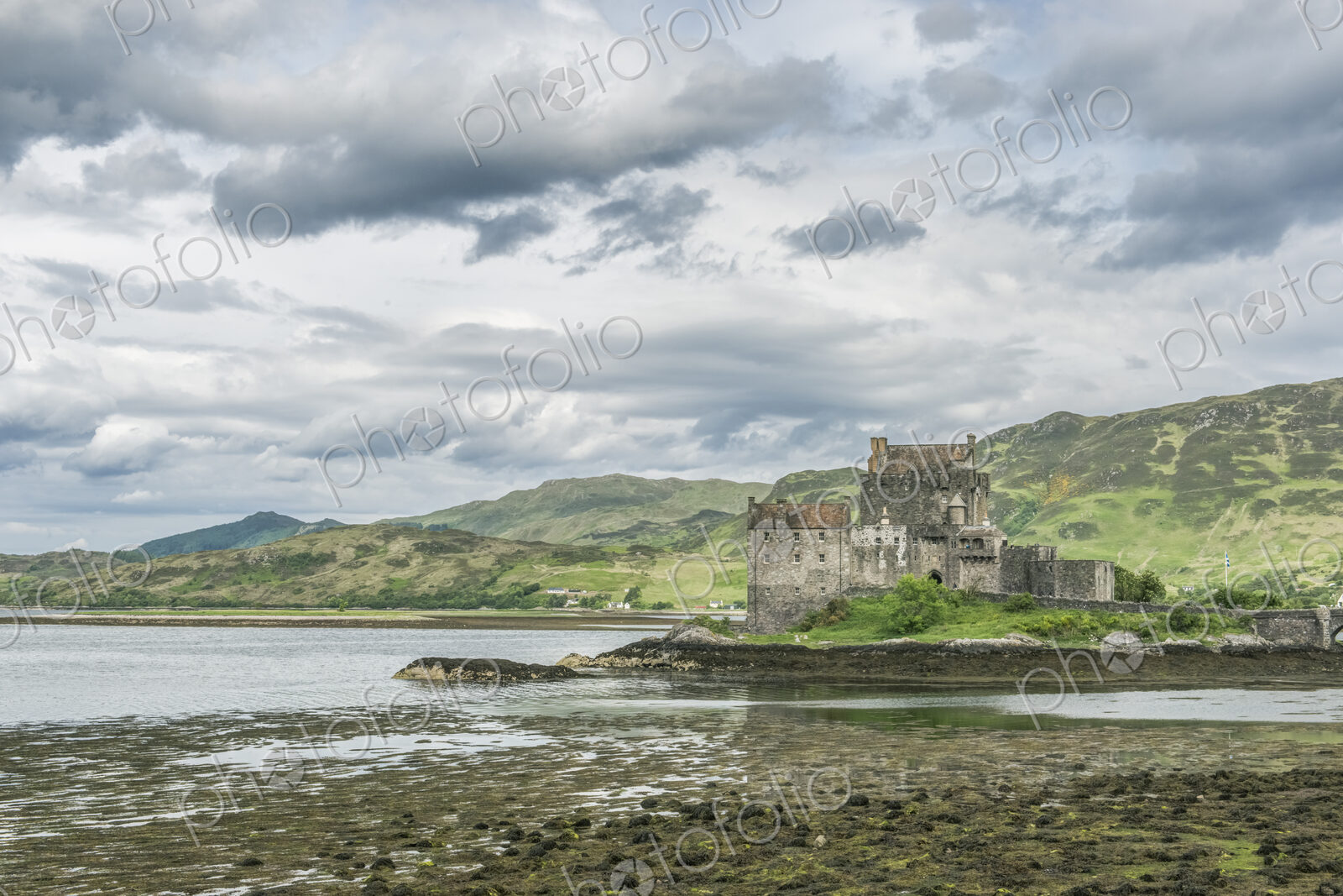 Eilan Donan, a remote castle on a tidal island with low tide.