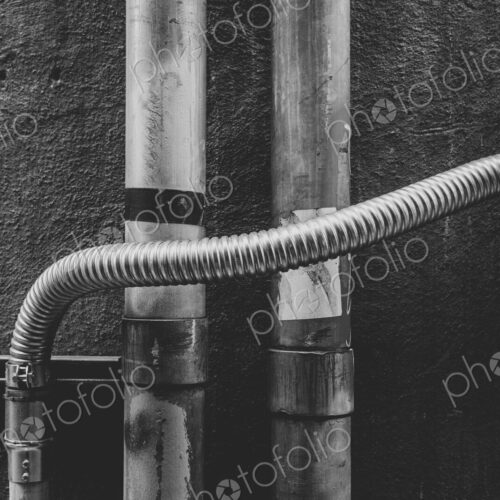 Electrical piping against building wall Electrical piping against building wall