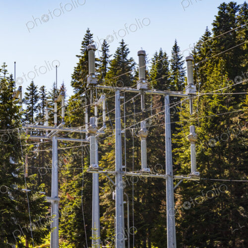 Electrical power lines on pylons running through trees. Electrical power lines on pylons running through trees.