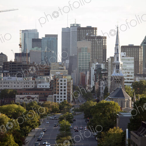 Elevated view of Quebec city, green space, tall buildings, major road and construction.