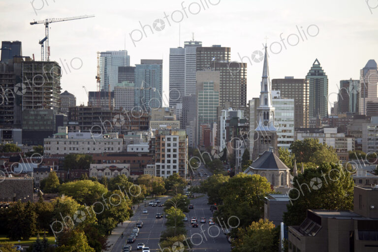 Elevated view of Quebec city, green space, tall buildings, major road and construction.
