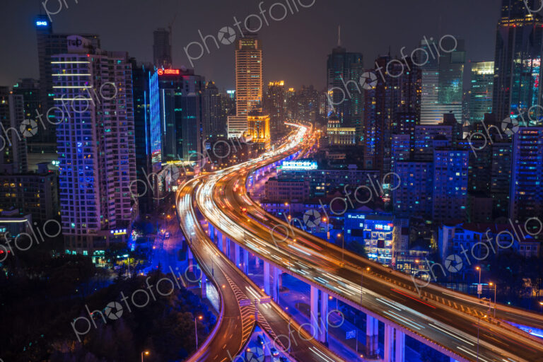 Elevated view of stacked road junction & Shanghai skyline at dusk, Shanghai, China