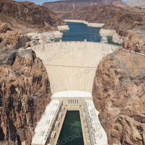 Elevated view of the Hoover Dam wall, buildings and the water pool at the base of the… Elevated view of the Hoover Dam wall, buildings and the water pool at the base of the…