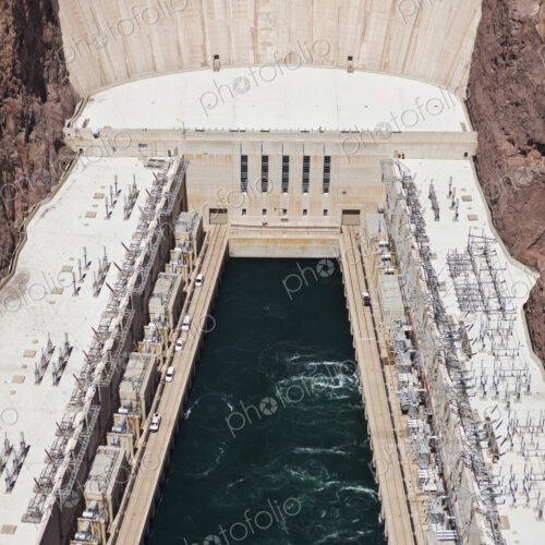 Elevated view of the Hoover Dam wall, buildings and the water pool at the base of the… Elevated view of the Hoover Dam wall, buildings and the water pool at the base of the…
