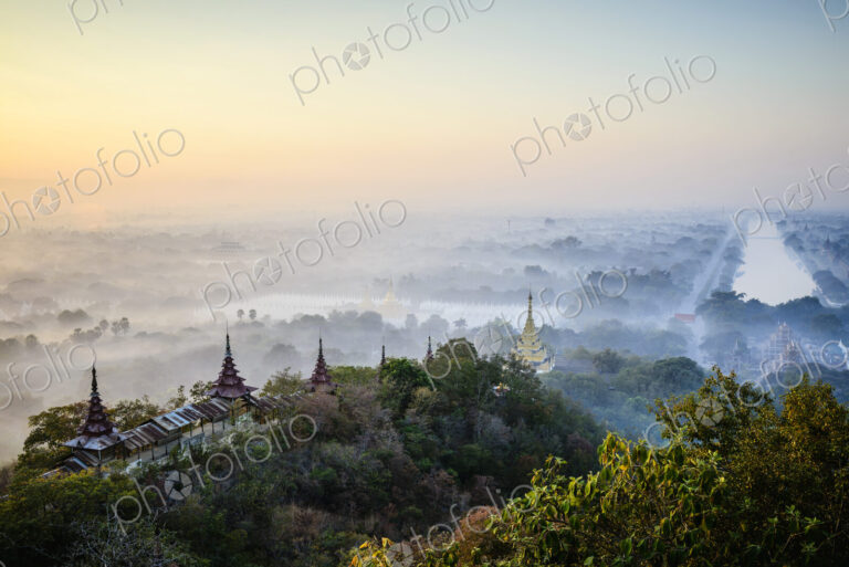 Elevated view of the plain of temples in Mandalay, stupas and spires emerging from the…
