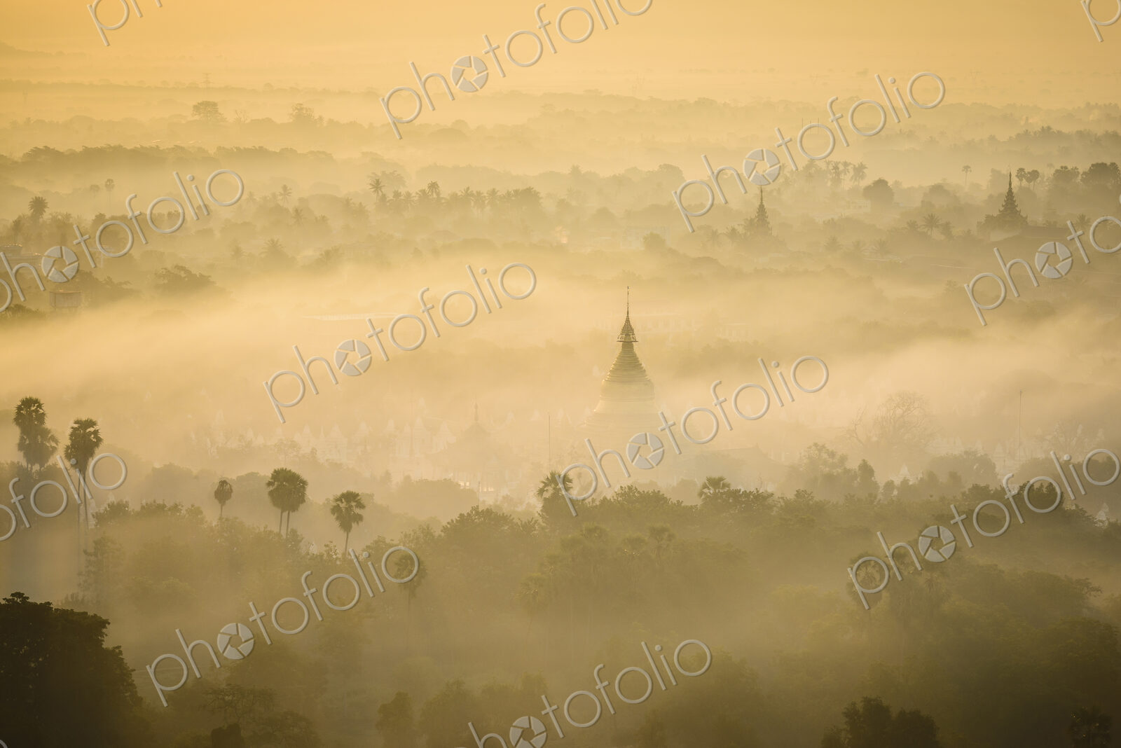 Elevated view of the plain of temples in Mandalay, stupas and spires emerging from the…