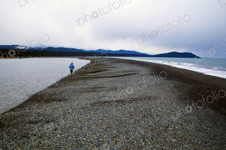 Elwha River estuary at Port Angeles, people walking along the shingle strand.