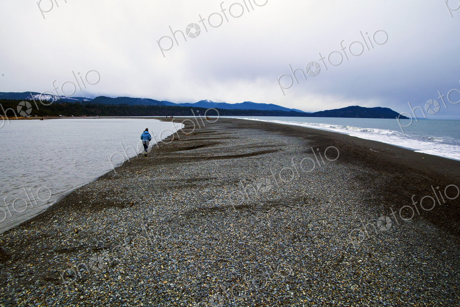 Elwha River estuary at Port Angeles, people walking along the shingle strand.