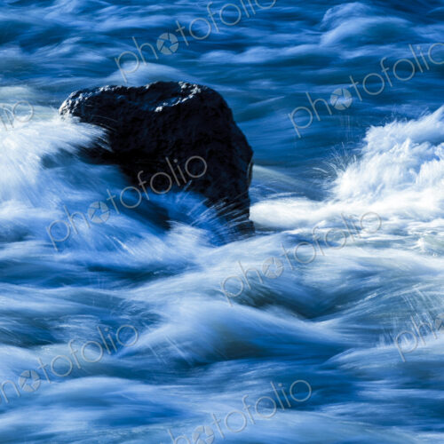 Elwha River flowing around rock, Port Angeles, WA USA Elwha River flowing around rock, Port Angeles, WA USA