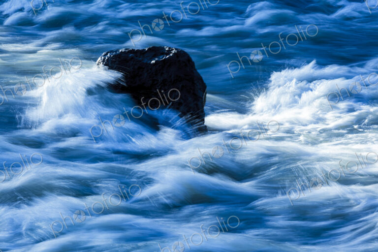 Elwha River flowing around rock, Port Angeles, WA USA