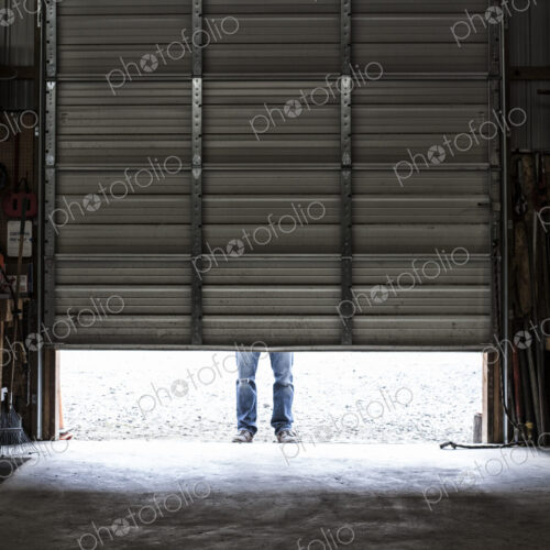 Employee coming to work walking in a loading dock doorway. Employee coming to work walking in a loading dock doorway.
