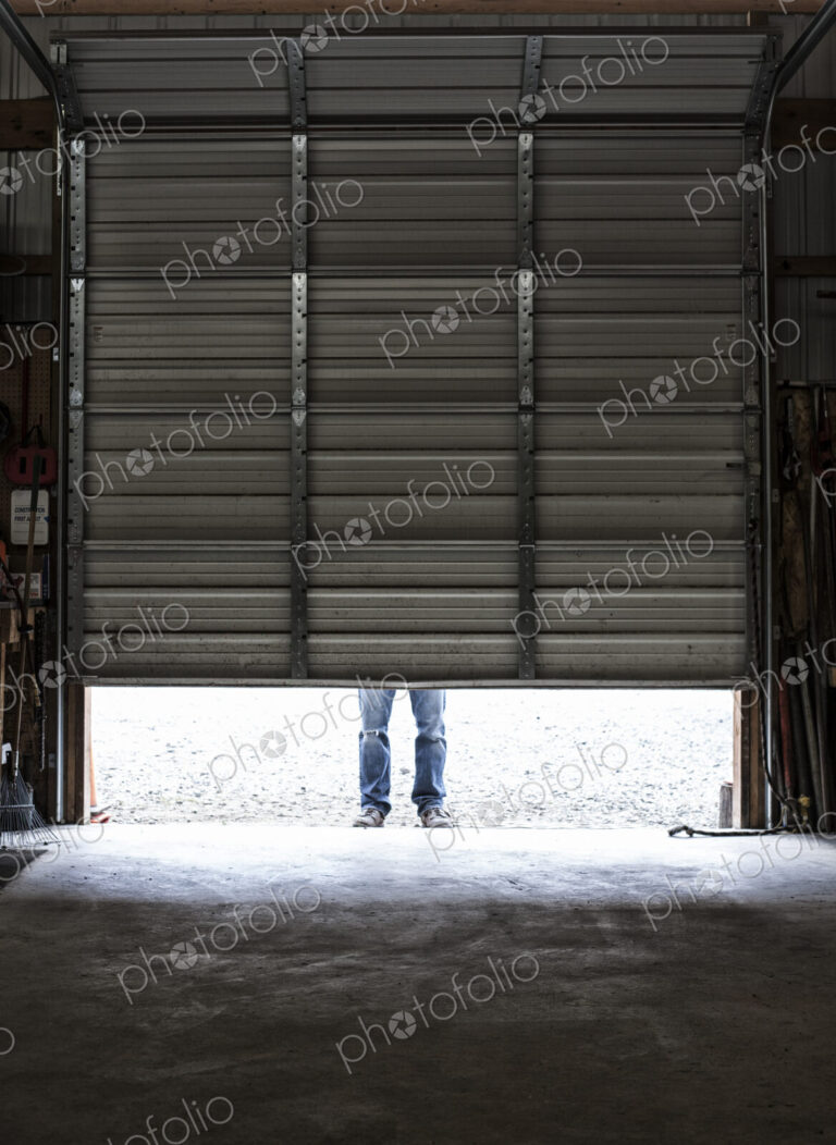 Employee coming to work walking in a loading dock doorway.