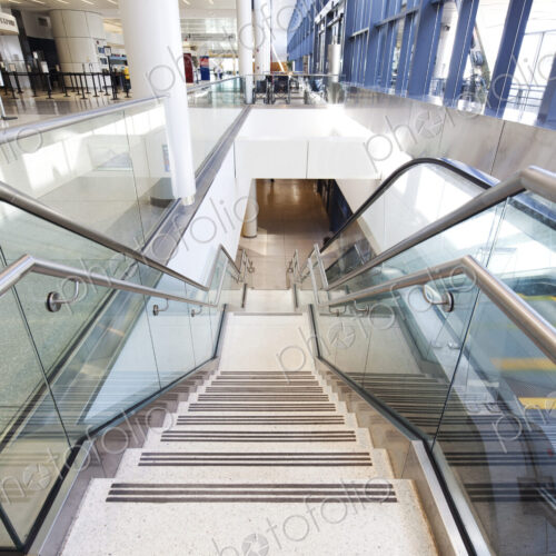 Empty airport interior, concourse and stairs and escalators