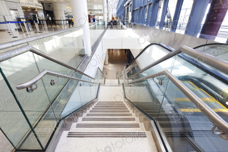 Empty airport interior, concourse and stairs and escalators