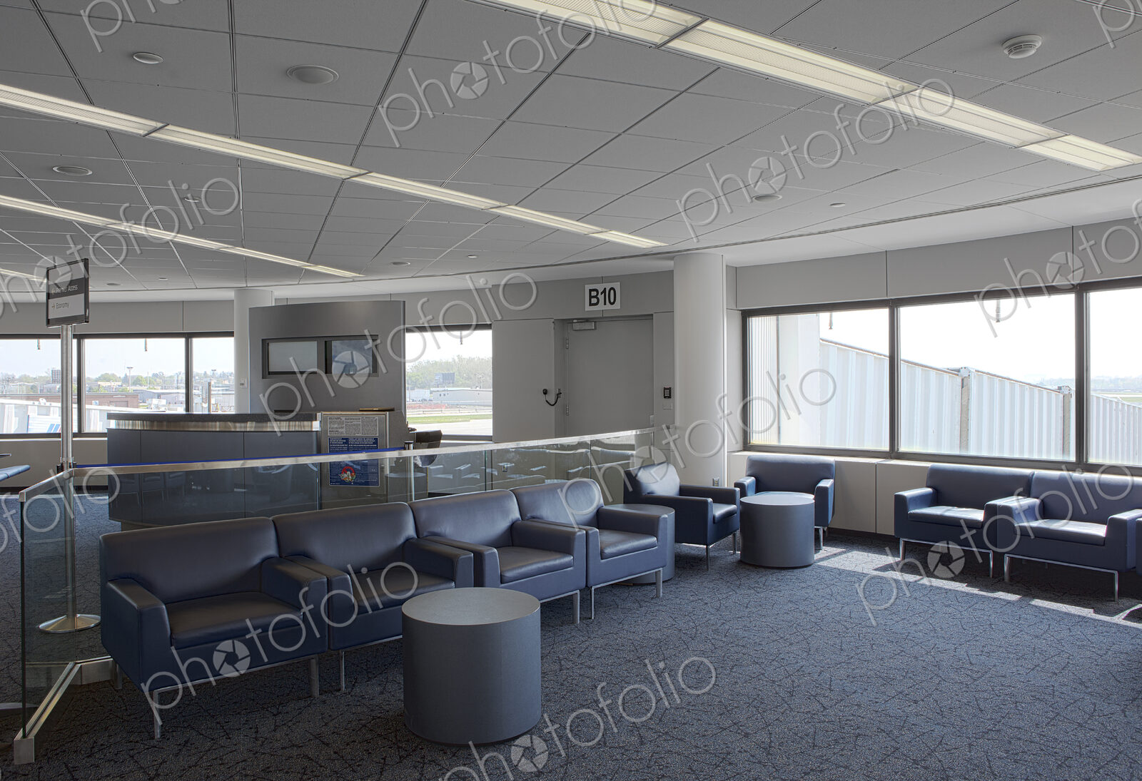 Empty airport lounge, with seats and windows, a departure gate lounge.