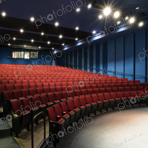 Empty auditorium, rows of raked seats. Empty auditorium, rows of raked seats.