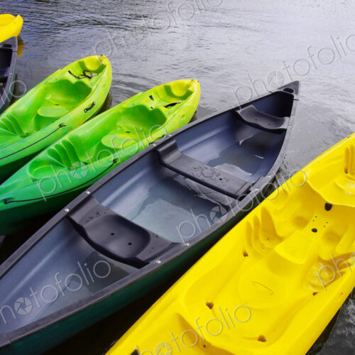 Empty canoes mooring on lake Empty canoes mooring on lake