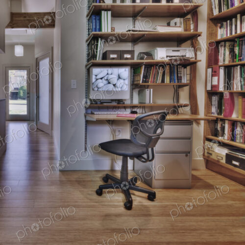 Empty desk and bookshelves in natural healing clinic office