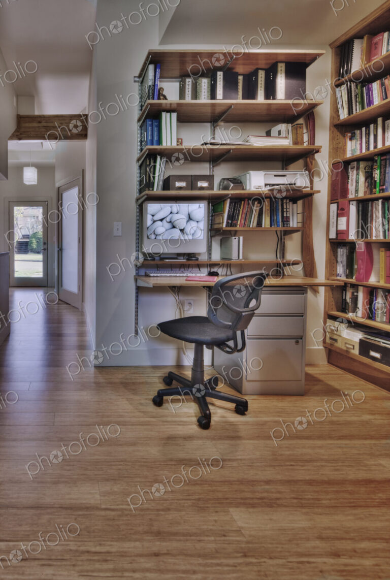 Empty desk and bookshelves in natural healing clinic office