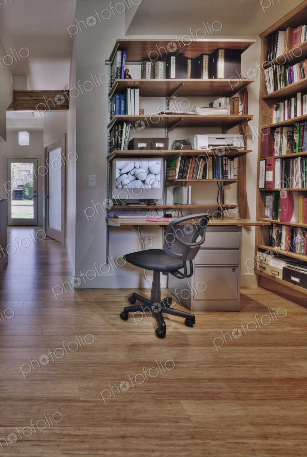 Empty desk and bookshelves in natural healing clinic office