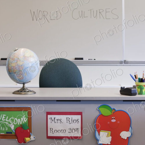 Empty desk of teacher in classroom