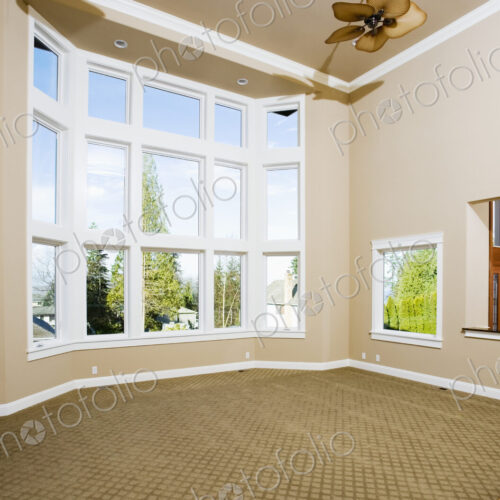 Empty living room with large windows Empty living room with large windows