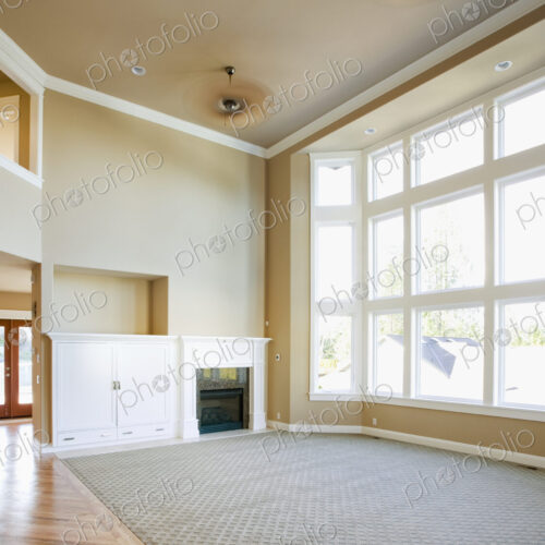 Empty living room with tall windows Empty living room with tall windows