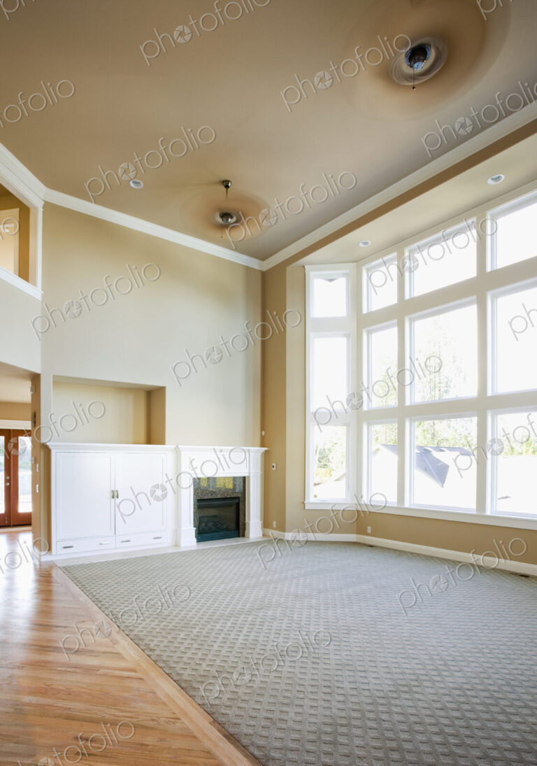 Empty living room with tall windows