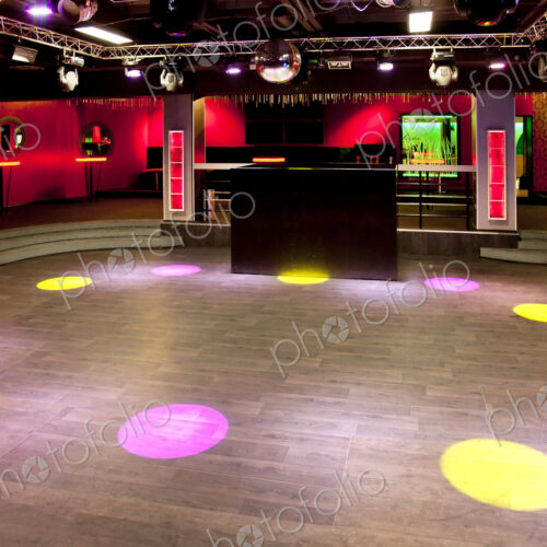Empty nightclub, coloured lights and spots, screens and DJ decks. Empty nightclub, coloured lights and spots, screens and DJ decks.