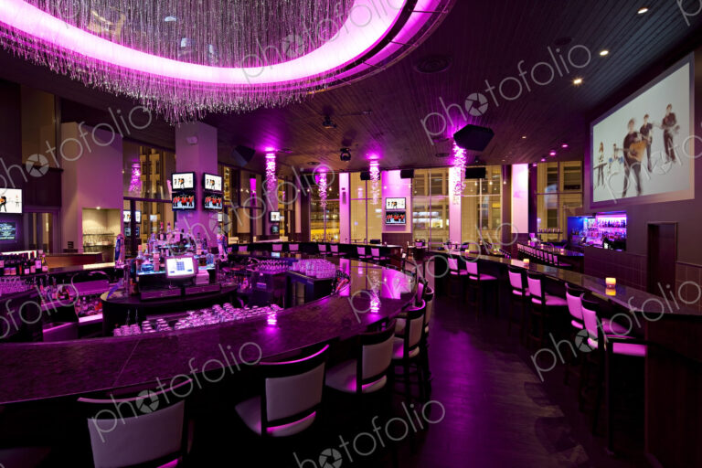 Empty nightclub illuminated with purple neon light