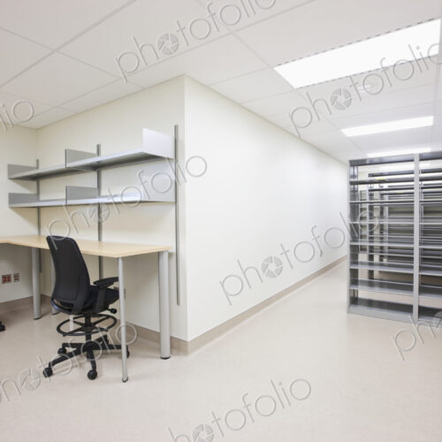 Empty office with desks chairs and server towers.