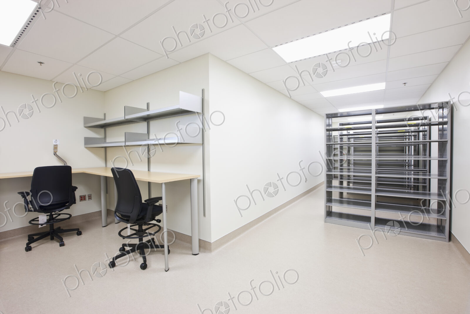 Empty office with desks chairs and server towers.