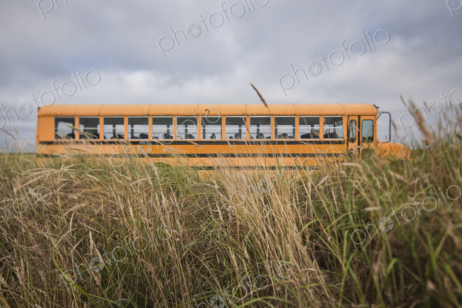 Empty school bus in grassland.