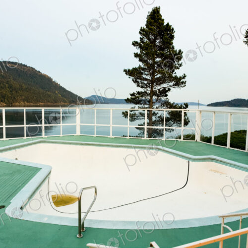 Empty swimming pool on a terrace overlooking the coastline of Orcas Island, off season. Empty swimming pool on a terrace overlooking the coastline of Orcas Island, off season.