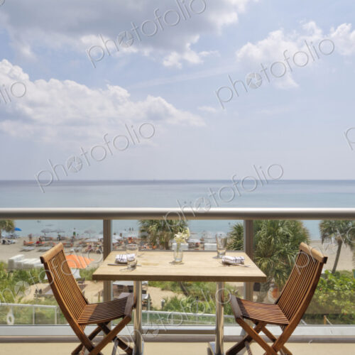 Empty table on restaurant balcony overlooking beach Empty table on restaurant balcony overlooking beach