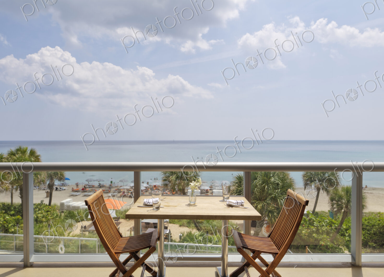 Empty table on restaurant balcony overlooking beach