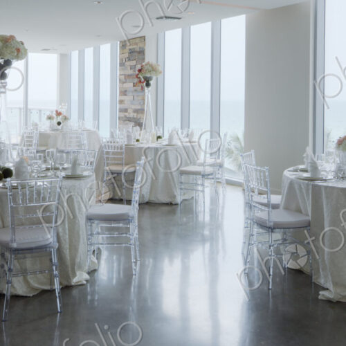 Empty tables in airy room with tables set for a wedding banquet Empty tables in airy room with tables set for a wedding banquet