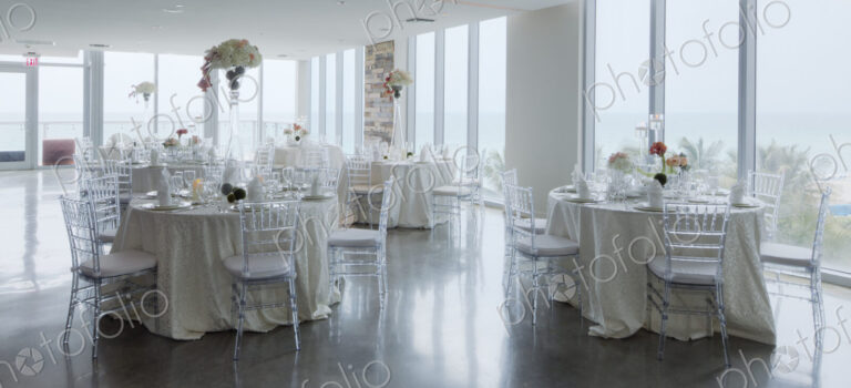 Empty tables in airy room with tables set for a wedding banquet